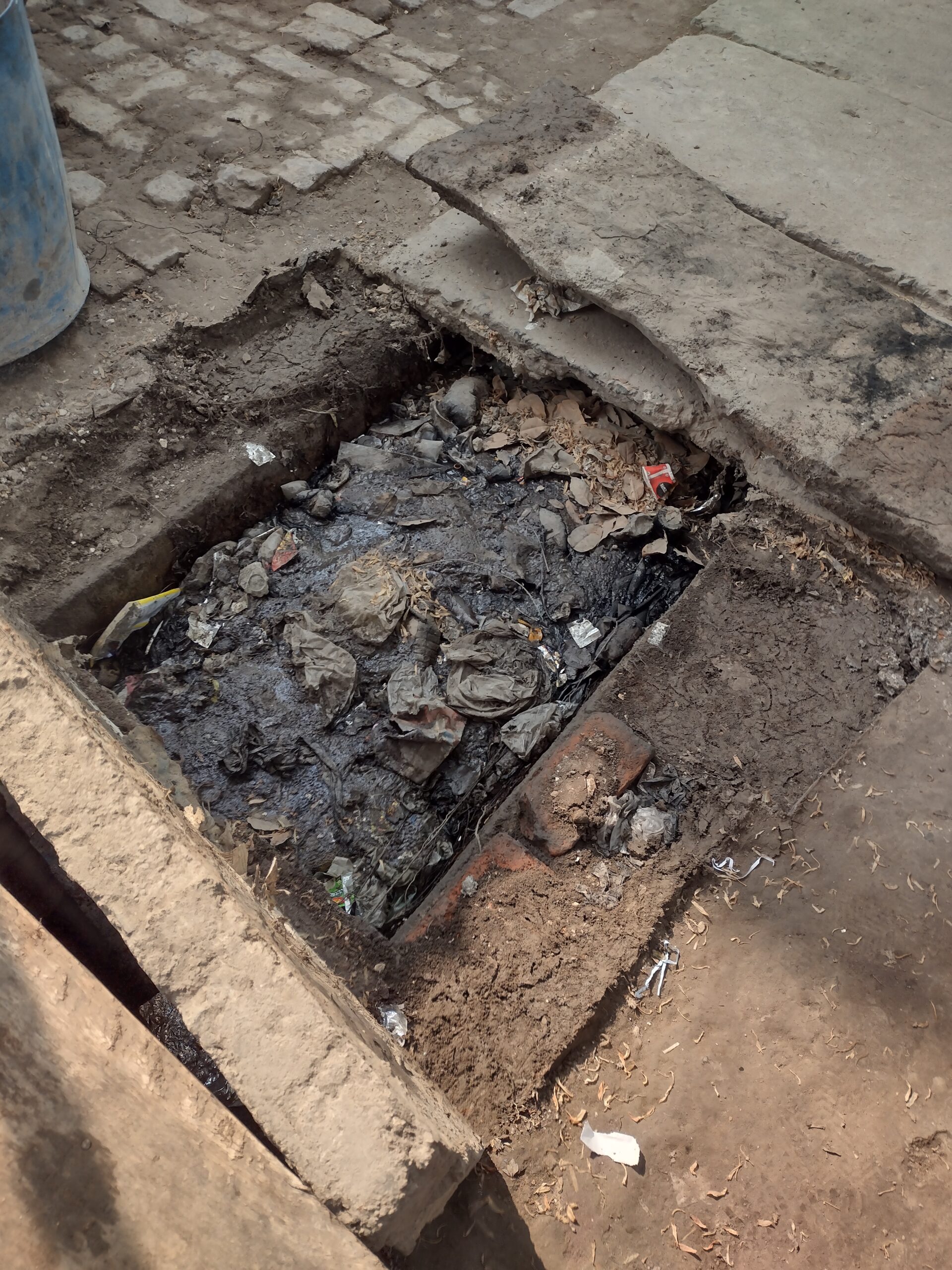 Open drain filled with garbage and waste